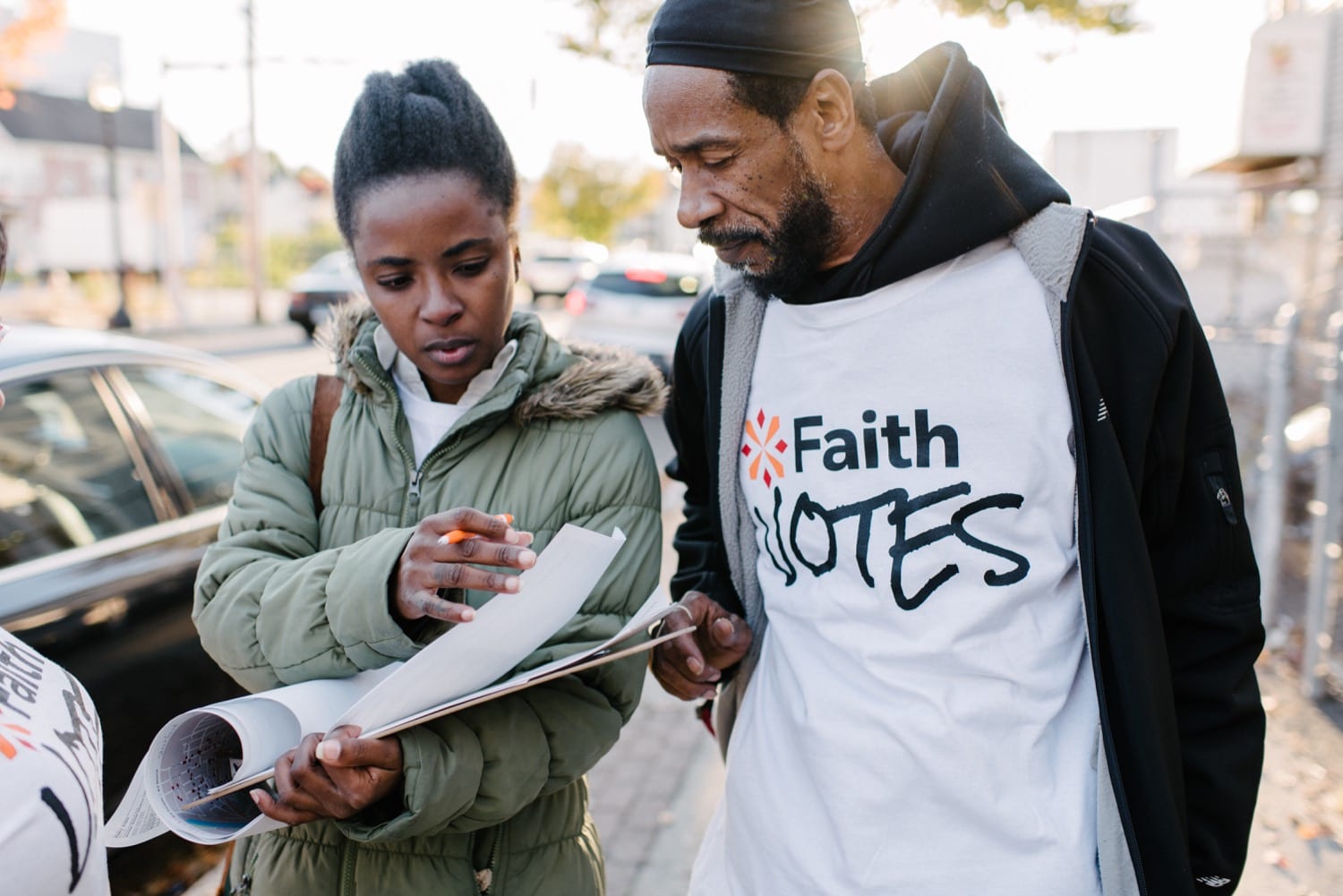 a black man and woman canvas neighbourhoods, educating them on how important it is to vote to have your voice heard! Image by Kristen Miller